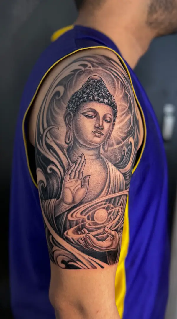 Realistic black and grey Buddha half sleeve tattoo by Diya Tattoo, Kathmandu, Nepal