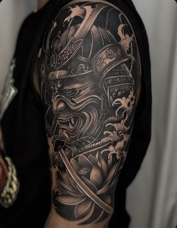 Black and grey Japanese samurai mask half sleeve tattoo with lotus and waves by Diya Tattoo, Kathmandu