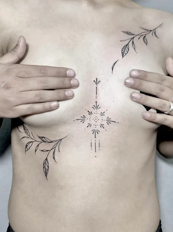 Minimal ornamental sternum tattoo with fine line leaves for women by Diya Tattoo, Kathmandu