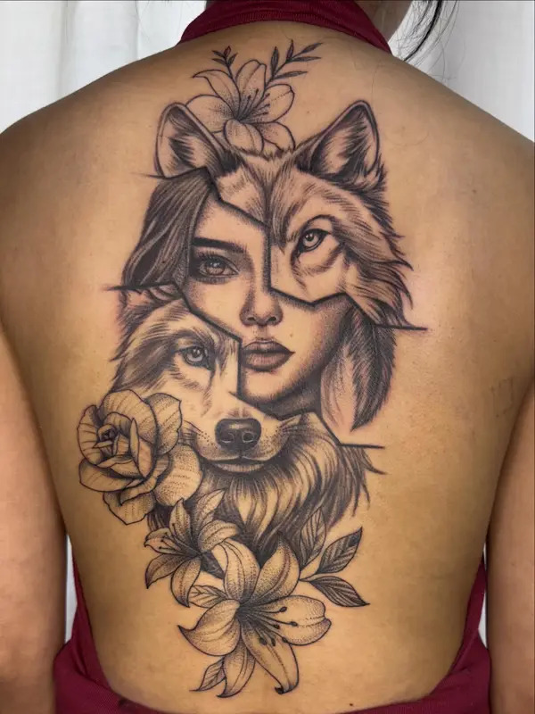 Wolf and woman face back tattoo with lilies and rose by Diya Tattoo, Kathmandu